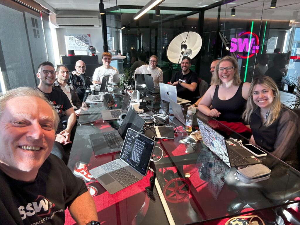 Group of colleagues around laptops